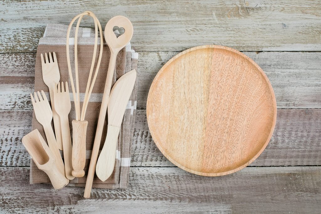 Top view of wooden plate and cutlery utensils on wooden table background. Empty plate.